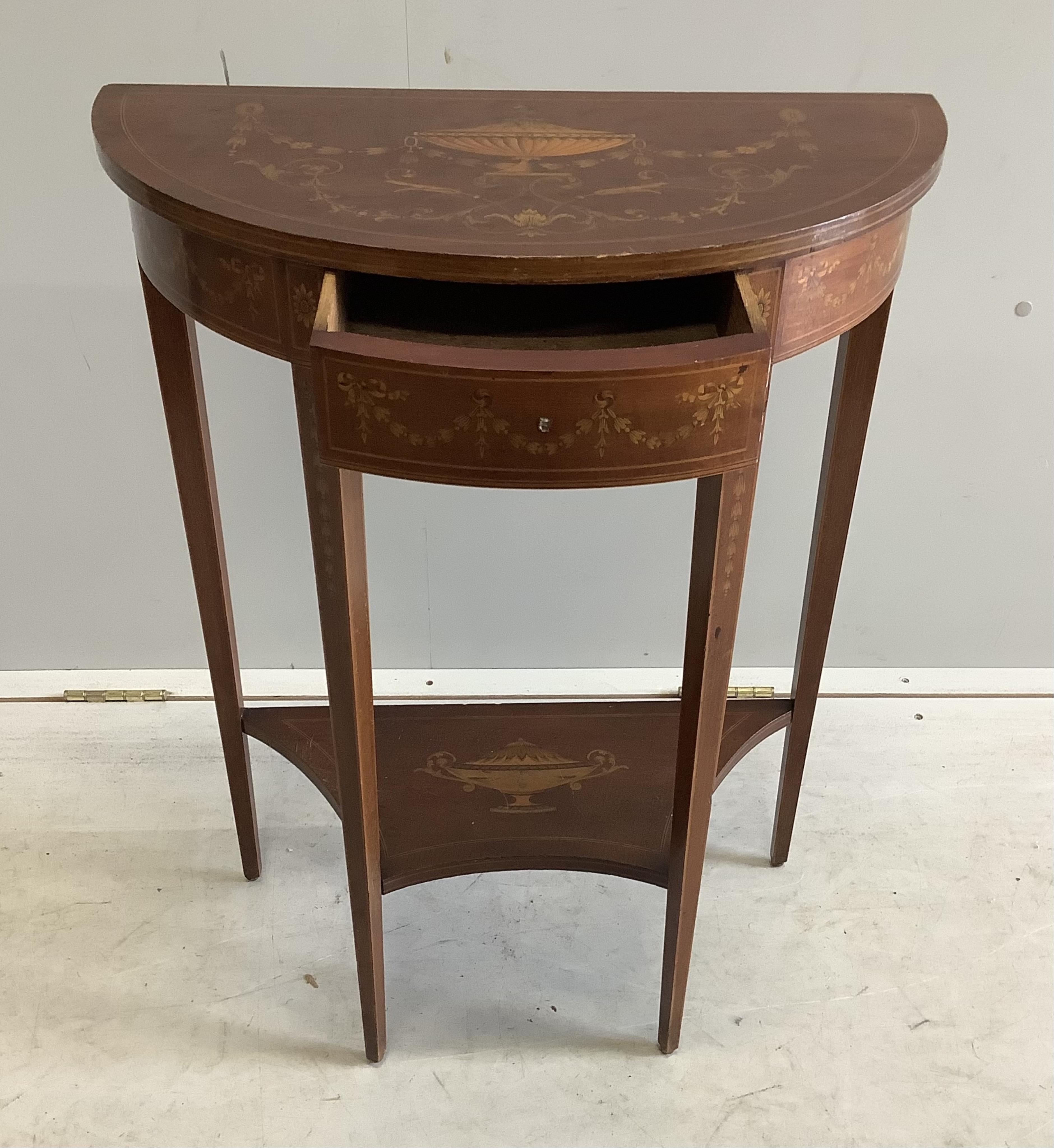 A Edwardian marquetry inlaid mahogany D shaped two tier side table in the manner of Edward & Roberts, width 57cm, depth 29cm, height 75cm. Condition - fair to good